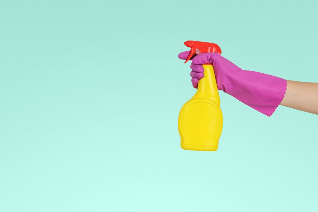 who-we-are person-holding-yellow-plastic-spray-bottle-zmnefoi3k