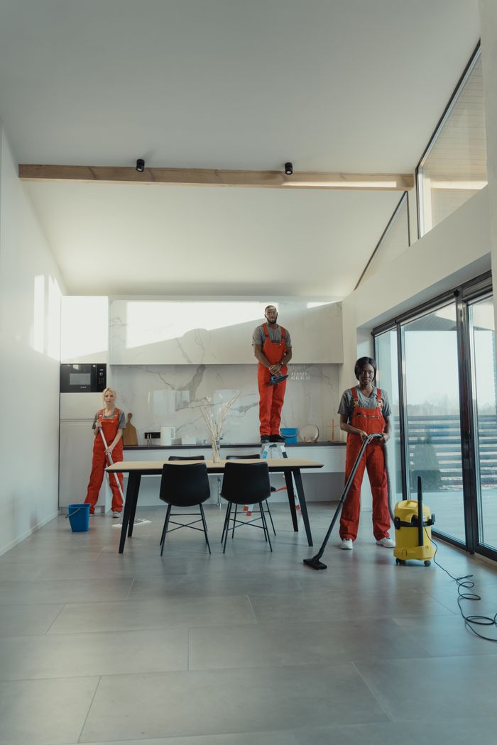team-02 Team of professional cleaners working in a spacious, modern indoor setting.